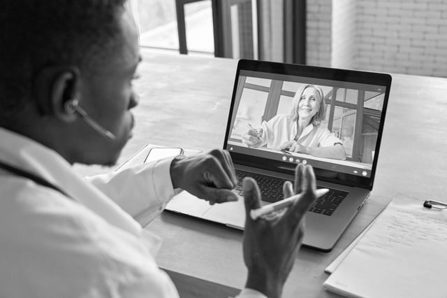 A physician talking with a colleague by video call