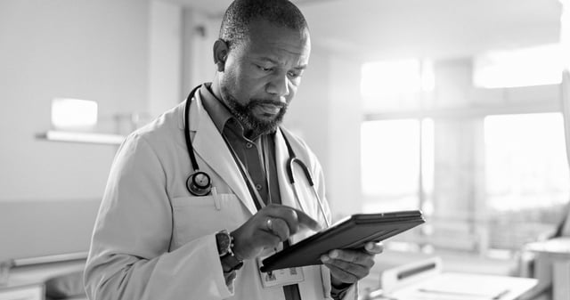 A physician reading a case request on a tablet