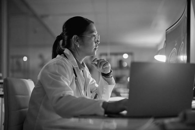 A physician reviewing imaging on screen